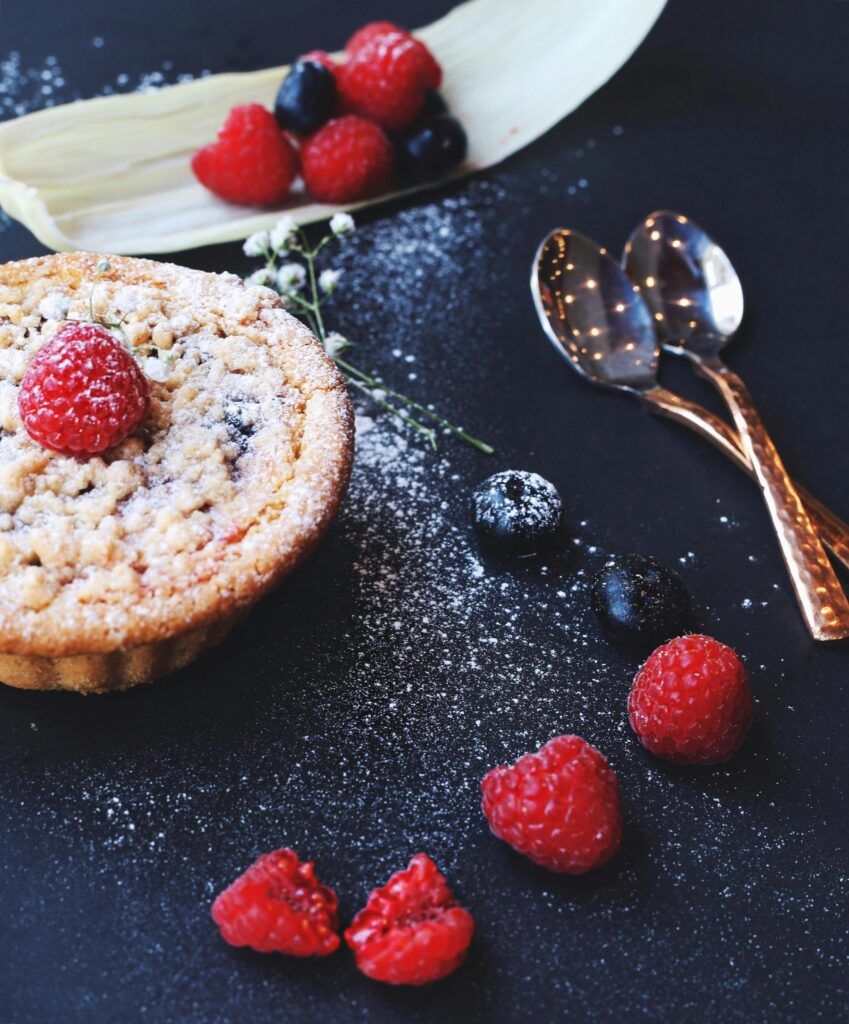 Close-up of a scrumptious berry tart adorned with fresh raspberries, perfect for dessert lovers.